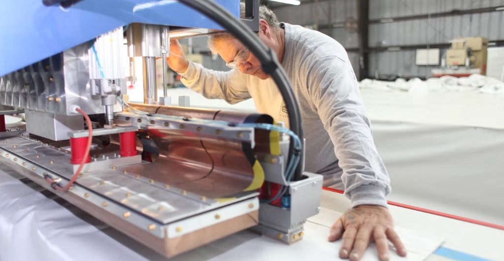 Eventstar technician inspecting industrial fabric manufacturing equipment