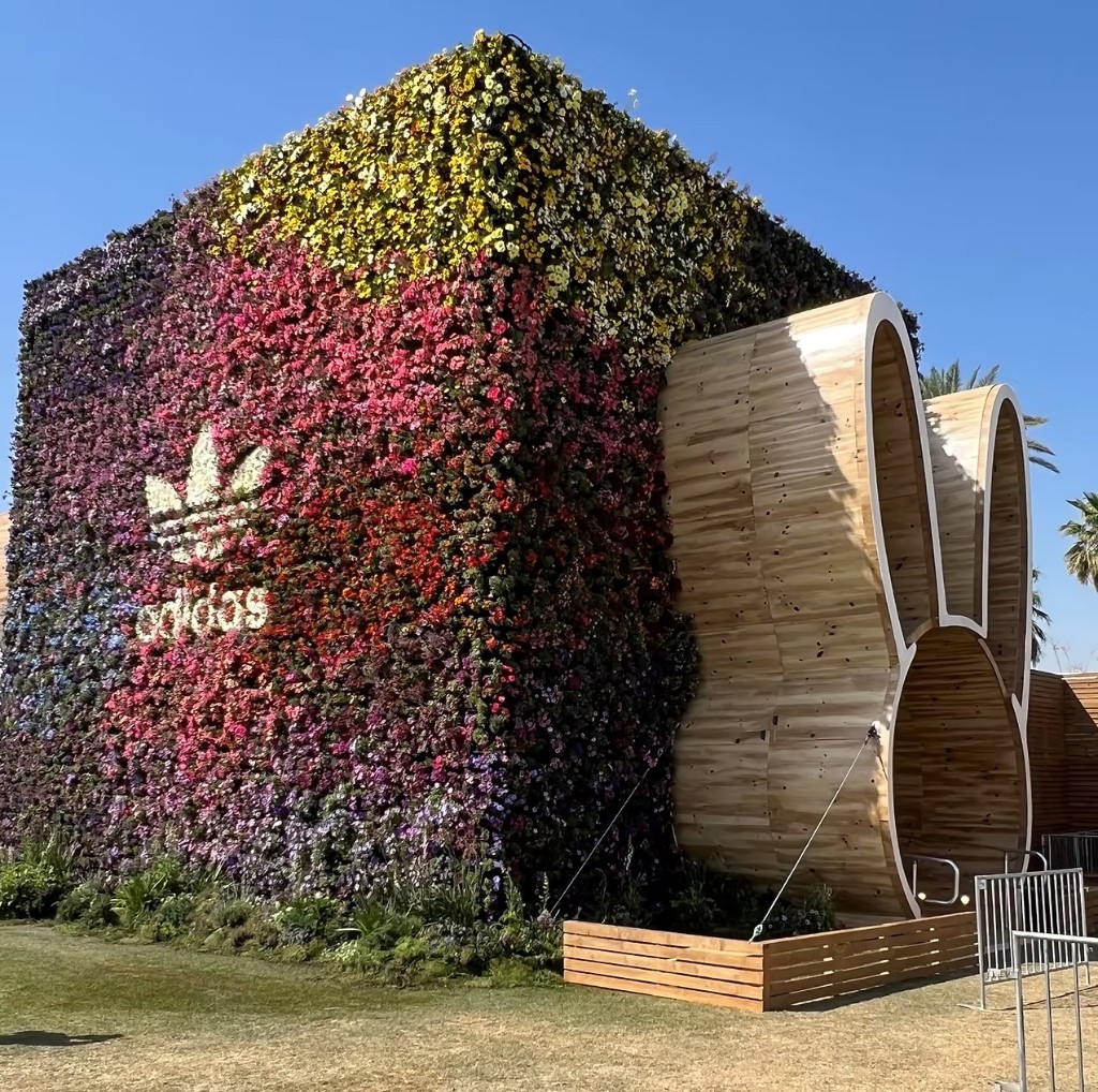 Custom brand activation structure with floral wall and wood fabrication